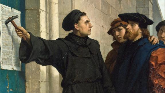Martin Luther posting his 95 theses on the church door in Wittenberg, Germany.
